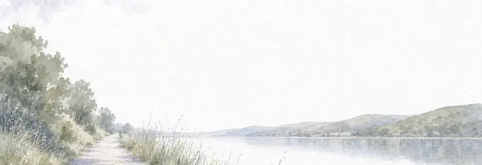 Watercolour of a level gravel trail running beside a wide still reservoir, tall grasses at the verge and low hills on the far shore.